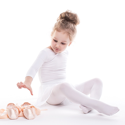 Little Ballerina and ballet shoes on a white background.